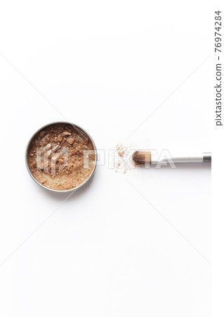 Light brown face shadow in container and eye shadow or make-up brush 76974284
