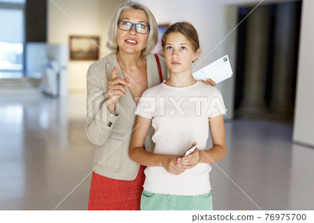 Woman and girl visiting museum Woman and girl visiting museum 76975700