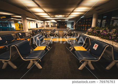 Seats and signs in the airport Seats and signs in the airport 76976763