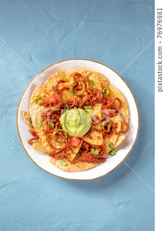 Nachos, Mexican tortilla chips, shot from above Nachos, Mexican tortilla chips, shot from above 76976981