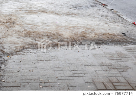 Ice on the footpath, background or texture 76977714