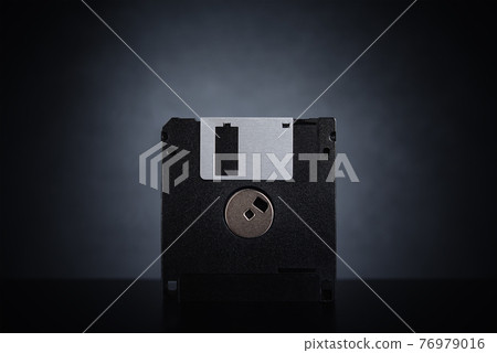 Floppy disk on dark background Floppy disk on dark background 76979016