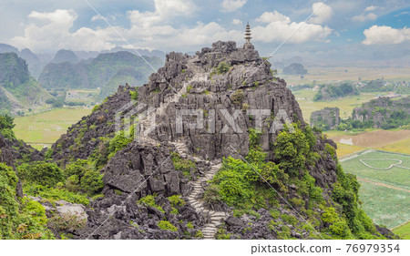 Top pagoda of Hang Mua temple, rice fields, Ninh Binh, Vietnam. Vietnam reopens borders after quarantine Coronovirus COVID 19 Top pagoda of Hang Mua temple, rice fields, Ninh Binh, Vietnam. Vietnam reopens borders after quarantine Coronovirus COVID 19 76979354