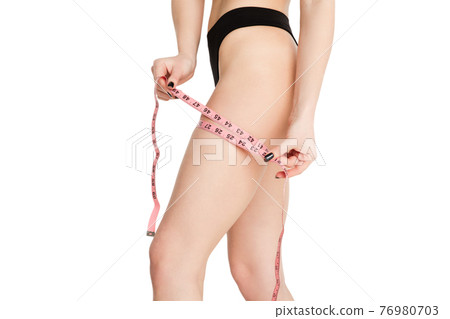 Cropped slim beautiful woman in underwear isolated over light background. Cropped slim beautiful woman in underwear isolated over light background. 76980703