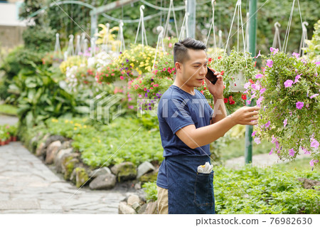 Greenhouse worker calling customer 76982630