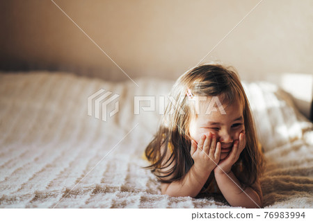 The child covers his face with his hands. The child is offended and lies on the bed. Raising and caring for children 76983994