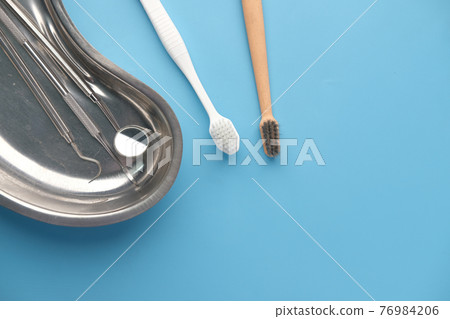 top view of dental equipment and tooth brush on blue background top view of dental equipment and tooth brush on blue background 76984206