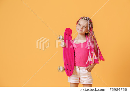 Active young girl with dreadlocks in pink shirt and shorts with 76984766