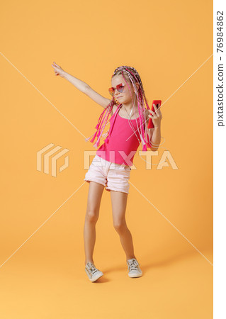 Beautiful European girl with dreadlocks. Mobile phone in the han 76984862