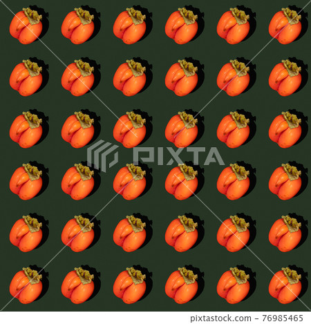 Seamless rhythmic pattern made of one ugly orange persimmon on dark green background. Zero waste food concept. Fresh healthy organic fruits. Reasonable sustainable consumption. Trendy hard shadows. 76985465