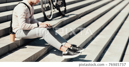 Remote work on street during coronavirus quarantine Remote work on street during coronavirus quarantine 76985737