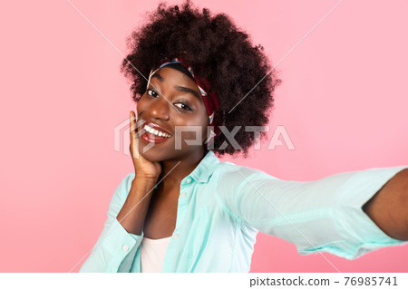 Pretty Black Woman Making Selfie Touching Face On Pink Background 76985741