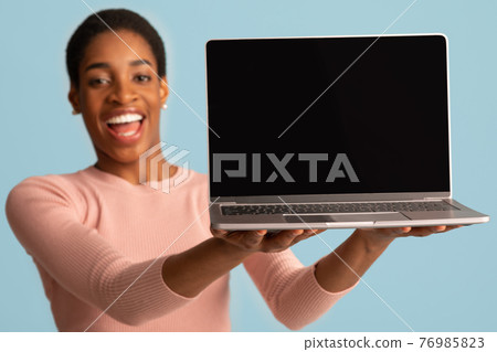 Joyful African American Lady Holding Laptop With Black Screen In Hands, Mockup Joyful African American Lady Holding Laptop With Black Screen In Hands, Mockup 76985823