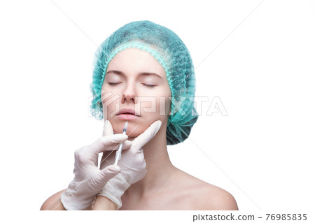Portrait of young Caucasian woman getting cosmetic injection Portrait of young Caucasian woman getting cosmetic injection 76985835