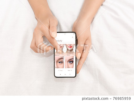 Augmented Reality Beauty App. Woman Trying Different Makeup Online Augmented Reality Beauty App. Woman Trying Different Makeup Online 76985959