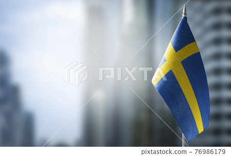 A small flag of Sweden on the background of a blurred background A small flag of Sweden on the background of a blurred background 76986179
