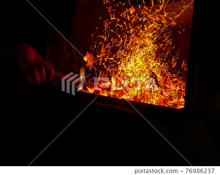 Fire place. Firebox with woodedn sticks. 76986237