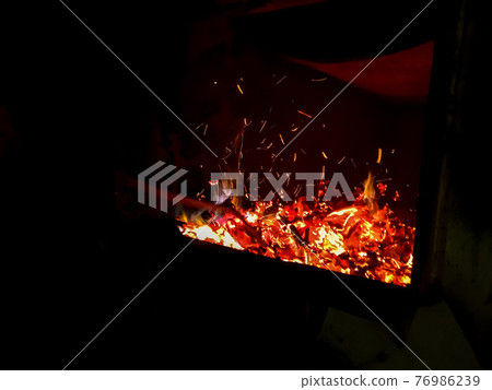 Fire place. Firebox with woodedn sticks. 76986239