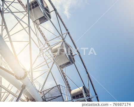 Gray or white metal ferris wheel with closed Gray or white metal ferris wheel with closed 76987174
