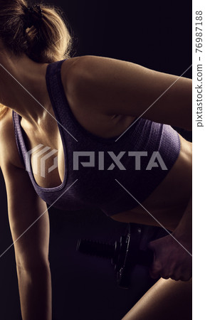 Slim beauty athletic woman on black background Slim beauty athletic woman on black background 76987188