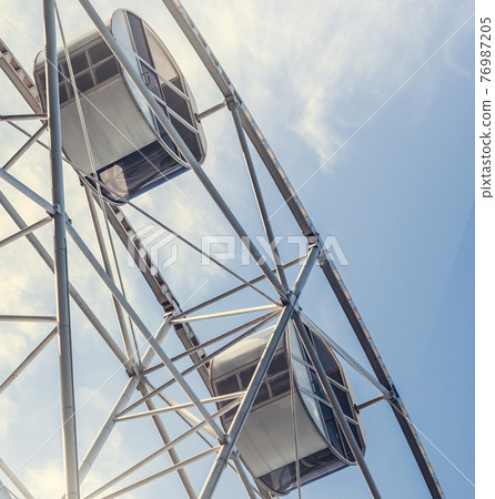 Gray or white metal ferris wheel with closed Gray or white metal ferris wheel with closed 76987205