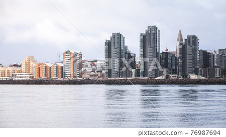 Urban skyline with modern buildings. Coastal view of Reykjavik 76987694