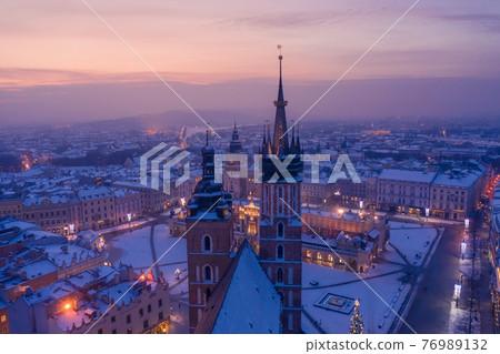 Main square Rynek of the Old Town of Krakow Poland in winter. St. Mary's Basilica Gothic church 76989132