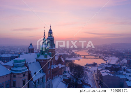 Wawel Royal Castle in winter. Snow on roofs of Wawel castle cathedral and Vistula river Wawel Royal Castle in winter. Snow on roofs of Wawel castle cathedral and Vistula river 76989571