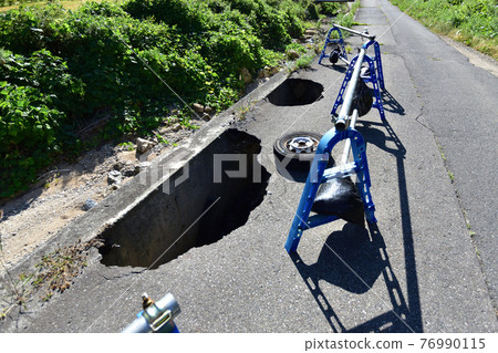 Depressed paved road Depressed paved road 76990115