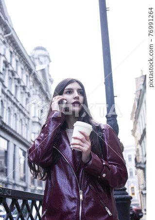 young pretty girl outside in city street with coffee happy smiling, lifestyle fashion peopple concept young pretty girl outside in city street with coffee happy smiling, lifestyle fashion peopple concept 76991264
