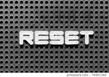 White alphabet letter in word reset on black pegboard background White alphabet letter in word reset on black pegboard background 76991360