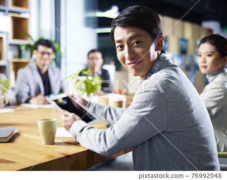 young asian designer business man looking at camera smiling during meeting 76992048