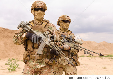 Two equipped and armed special forces soldiers Two equipped and armed special forces soldiers 76992190