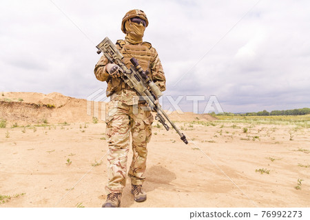 Equipped and armed special forces soldier with rifle 76992273