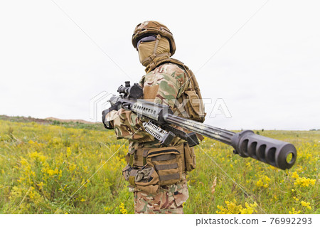 Equipped and armed special forces soldier in the field Equipped and armed special forces soldier in the field 76992293
