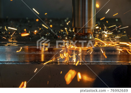 The CNC milling rough cutting with burning chip. The CNC milling rough cutting with burning chip. 76992689