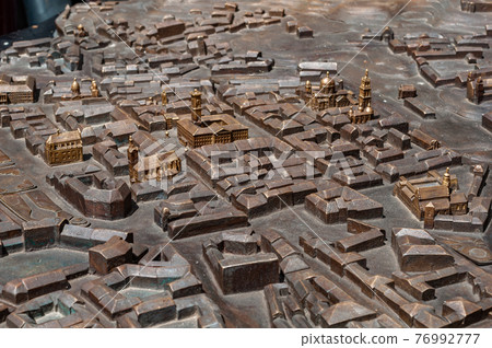 Model city made bronze close-up, houses and streets are not detailed, some buildings are more detailed highlighted in golden color 76992777