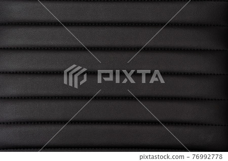 Black artificial leather background, textured surface material close-up.  76992778