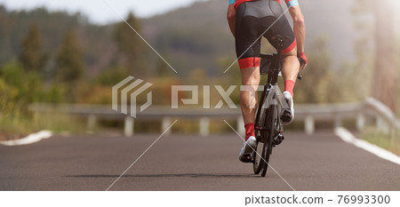Road bike cyclist man cycling, athlete on a race cycle Road bike cyclist man cycling, athlete on a race cycle 76993300