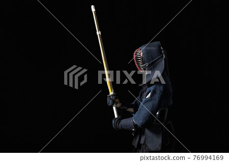 Kendo fighter with with shinai 76994169