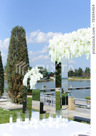 White wonderful wedding arch with lake in backround. White wonderful wedding arch with lake in backround. 76994464