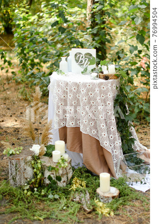 White little decorated wedding table near altar outside. 76994504