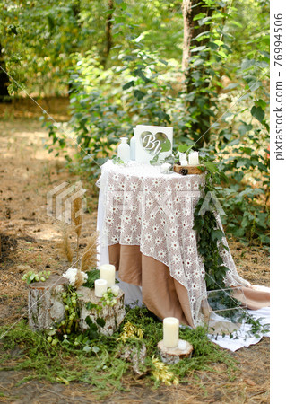 White decorated wedding table near altar outside. 76994506