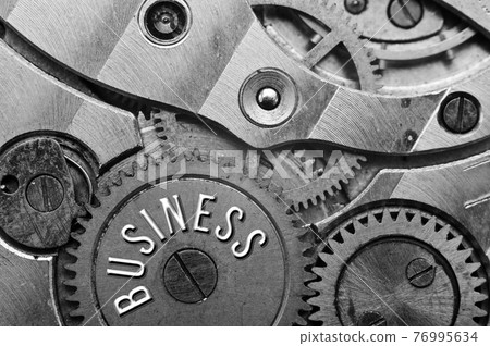 Black white background with metal gear wheels of the old clockwork. Conceptual photo for successful business design. Macro. Black white background with metal gear wheels of the old clockwork. Conceptual photo for successful business design. Macro. 76995634