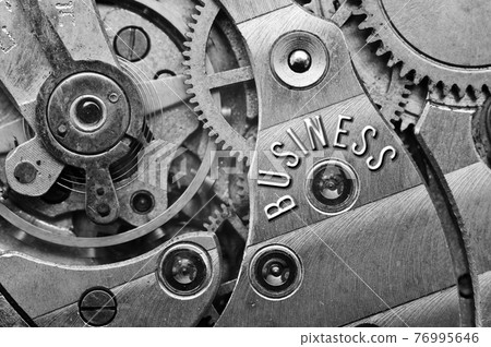 Black white background with metal gear wheels of the old clockwork. Conceptual photo for successful business design. Macro.  76995646