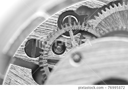 Black white background with metal gear wheels of the old clockwork. Conceptual photo for successful business design. Macro.  76995872