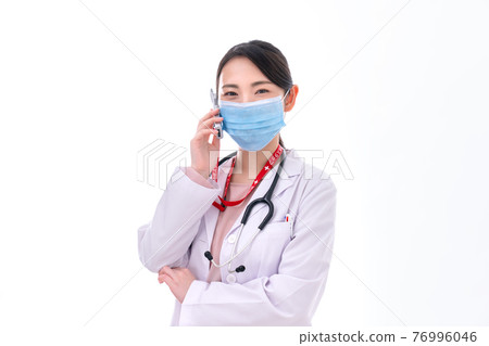 Young female doctor making a phone call 76996046