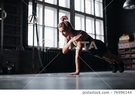 Young girl doing sports in the gym. Atmospheric gym 76996144