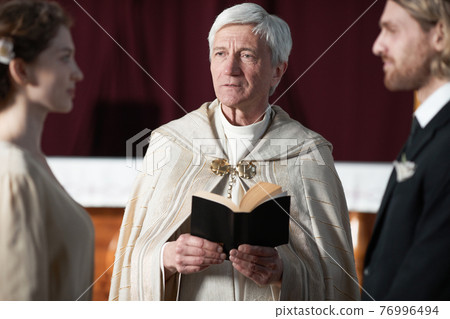 Priest marrying the couple 76996494