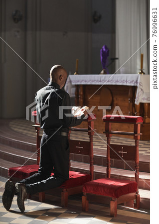 Catholic praying in the church 76996631